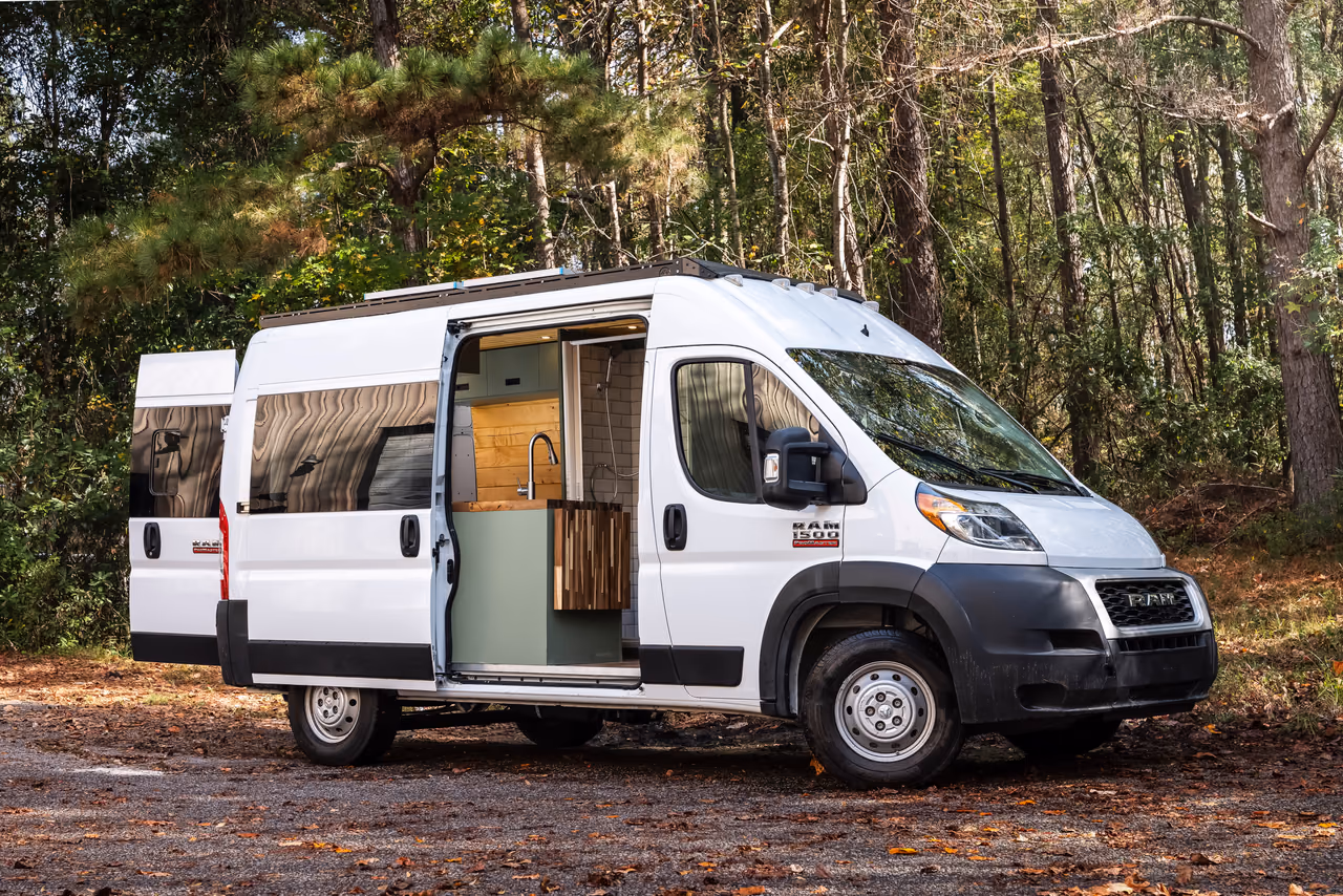A finished RAM campervan parked outside with the doors open